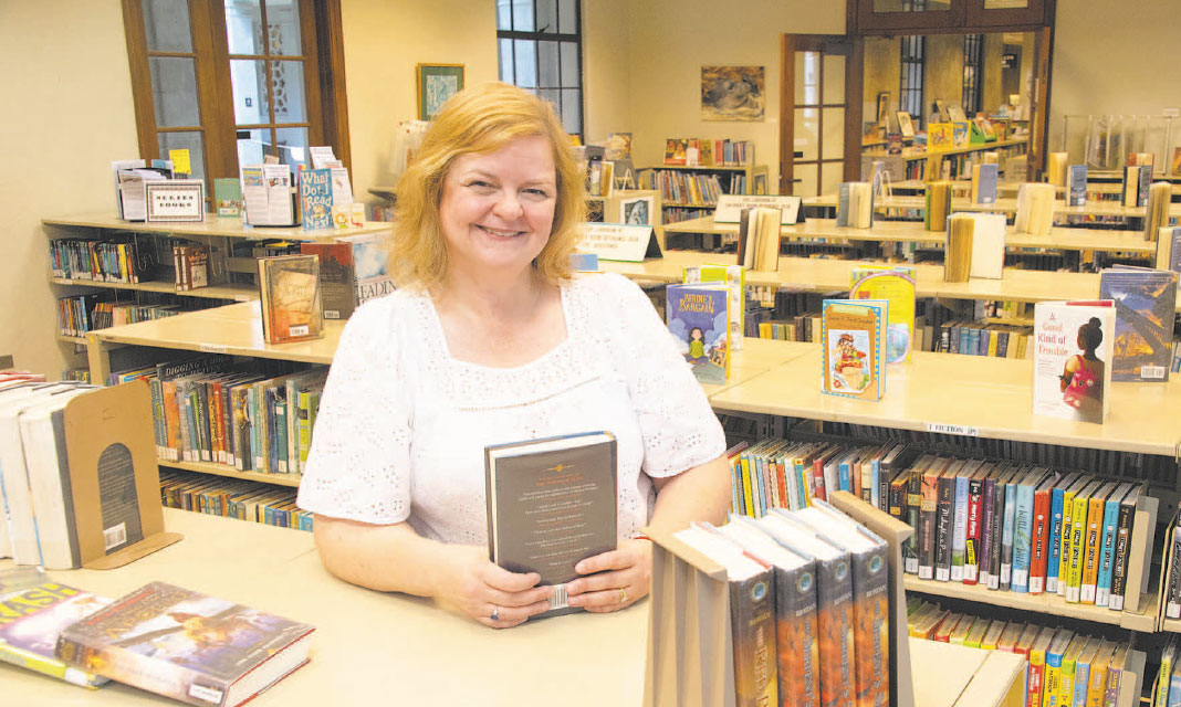 Librarian Stacey Aldrich. shown at the flagship state library on South King St